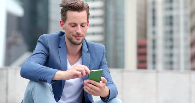 Caucasian business man use of cellphone in Hong Kong ciy