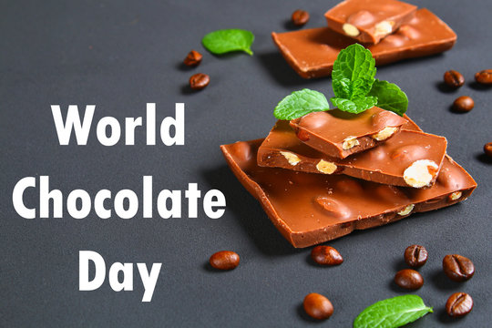 chocolate with almonds on dark grey background. July 11 is the day of chocolate.