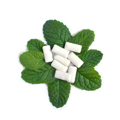 Mint leaves and bubble gum pads on white background