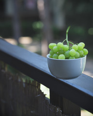 grapes on wooden railing, standing out effect, vintage effect, rustic style