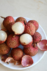 Fresh and juicy lychees on neutral background.