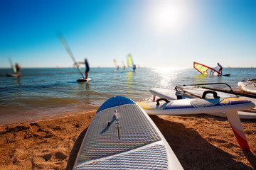 Windsurf boards on the sand at the beach. Windsurfing and active lifestyle