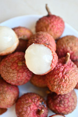 Fresh and juicy lychees on neutral background.