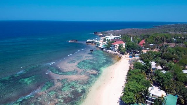 Aerial drone shots of a white sand beach with blue waters in an exotic place in the Philippines, southeast asia