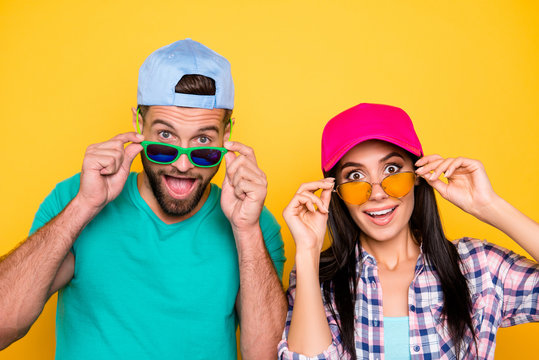 Head shot portrait of surprised glad students with unexpected unbelievable expression looking out eyewear with wide open mouth eyes isolated on vivid yellow background