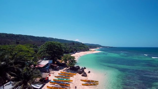 Aerial drone shots of a white sand beach with blue waters in an exotic place in the Philippines, southeast asia