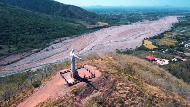 Aerial drone video of Christ the Redeemer on top a mountain in the Philippines, Asia.