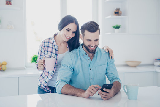 Apps electronic wireless device technology social networks connection communication concept. Portrait of joyful couple watching video on smart phone using wi-fi internet