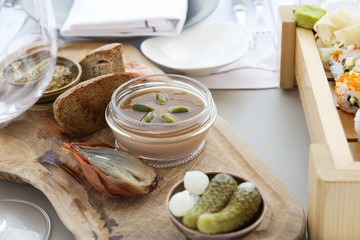 the Pate of foie gras with baked gooseberry and olives on a wooden board in a restaurant
