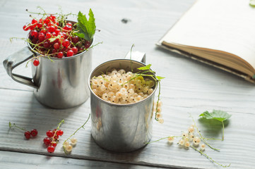 White and red currant in metal mugs