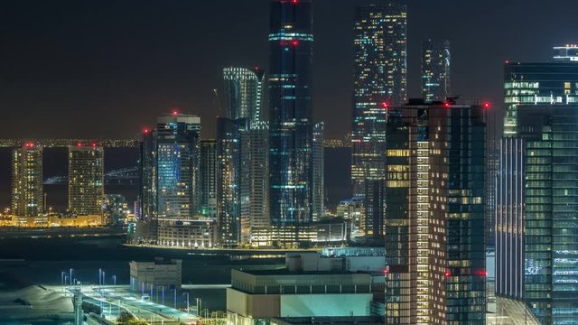 Aerial skyline of Abu Dhabi city centre from above night timelapse