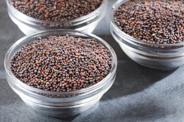 Black mustard seeds in bowls - Brassica nigra