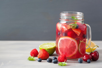 summer berry lemonade with lime and mint in mason jar