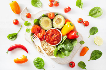 vegan buddha bowl. healthy lunch bowl with avocado, tomato, bell peppers, quinoa and salsa