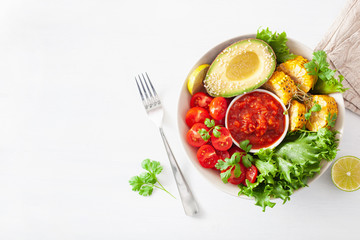 vegan buddha bowl. healthy lunch bowl with avocado, tomato, sweet corn and salsa