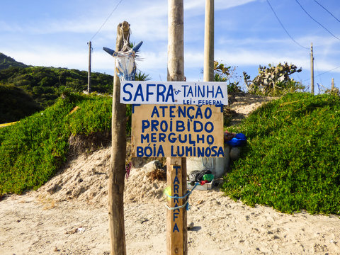 Florianopolis, Brazil - Circa May 2018: Sign at Ingleses beach informing that diving and other similar activities are forbidden in the mullet season