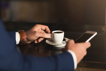 Man using mobile phone in coffee bar