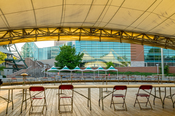 Public pavilion stage with chairs and table for event - obrazy, fototapety, plakaty