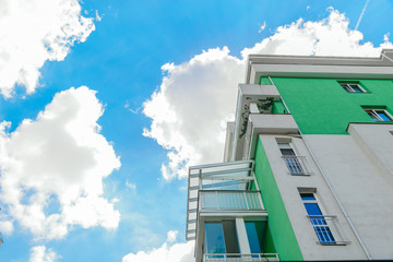 building facade blue sky with white clouds on background