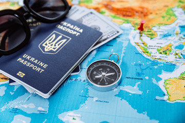 travel concept. two passports with compass on world map and sunglasses