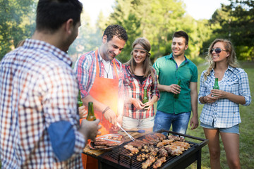 Young people grilling outdoors