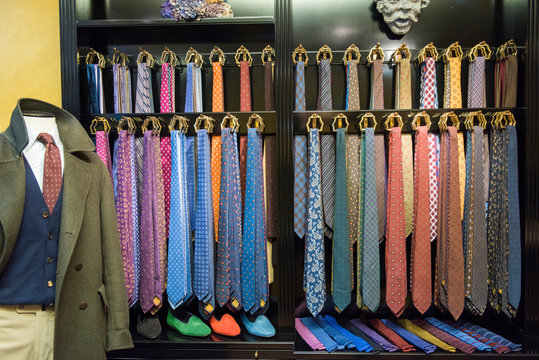 Rows of ties and tailors dummy in traditional tailors shop