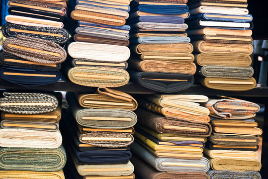 Stacks of rolled cloth in traditional tailors shop