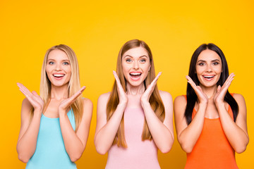 Great! Portrait of amazed pleased trio holding palms near face having good news information...