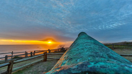 Sunset at the beach with a cannon