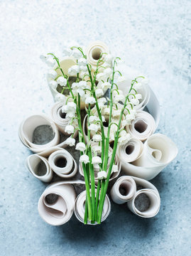 Lily of the valley cut flowers on curled ribbons, overhead view