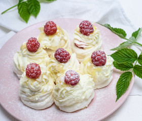  cakes made of egg white and whipped white cream with raspberries