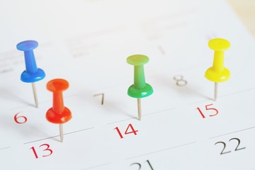 mark the event day with a pin. Thumbtack in calendar concept for busy timeline organize...