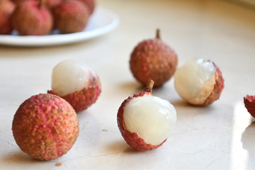Fresh and juicy lychees on neutral background.