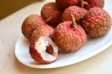 Fresh and juicy lychees on neutral background.