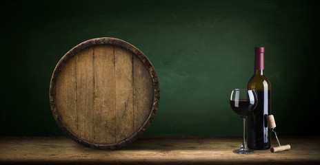 red wine bottle and wine glass on wodden barrel