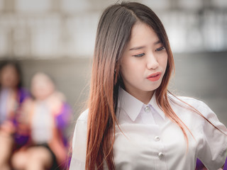 asian girl and graduate portrait concept from beautiful woman(20s to 30s)with long hair in white shirt during smile post , feel good and happy with asia city background