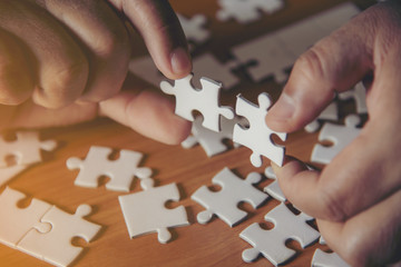 Hand holding jigsaw puzzles, Business partnership concept.
