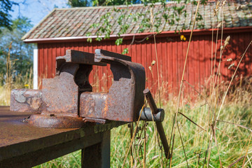 Workbench with a rusty vise outdoors