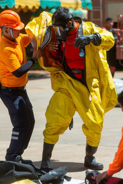 Fireman wear hazard protection suit or bright yellow hazmat (hazardous material) suits, preparing
