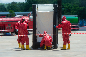 Fireman wear hazmat (hazardous material) suits in hot zone tent