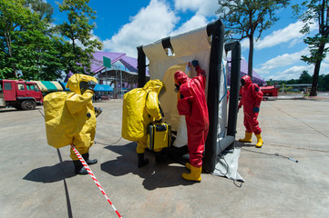 Fireman wear hazmat (hazardous material) suits in hot zone tent