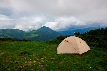 Tent on the green mountain meadow