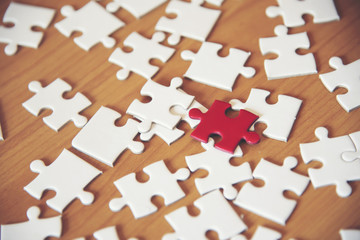 The business team consists of a jigsaw puzzle representing the support team and the concept.