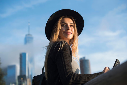Portrait of woman wearing hat looking away smiling, New York, USA