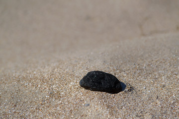 Fototapeta na wymiar Sand texture, stone on sand