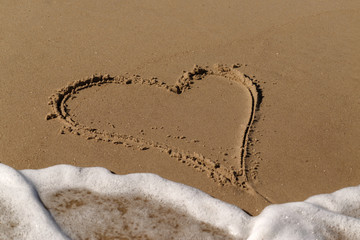 Heart in the sand, surf, wave
