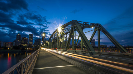 Hawthorne Bridge in Portland, Oregon, USA, at sunset, with city skyline in the background