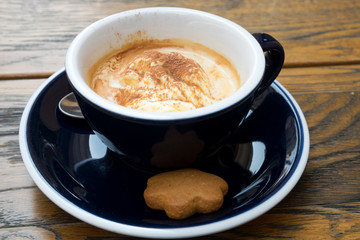 A cup of delicious morning affogato coffee with a ball of tasty vanilla ice cream and homemade ginger cookie