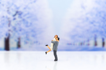 Miniature people: Couple show each other to show love, travel together . Image use for Valentine's day concept.