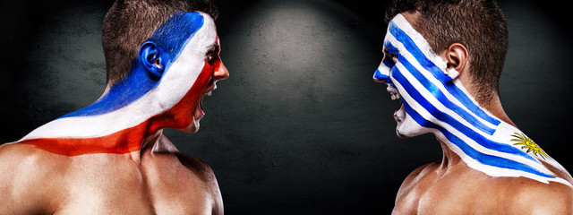Soccer or football fan with bodyart on face - flags of Uruguay vs France. Sport Concept with copyspace.